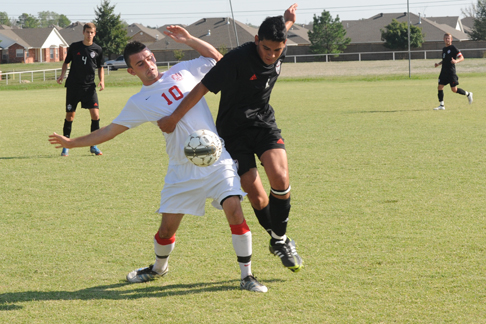 Junior Stephen Cummins fights to control the ball against Oklahoma Wesleyan on September 25.